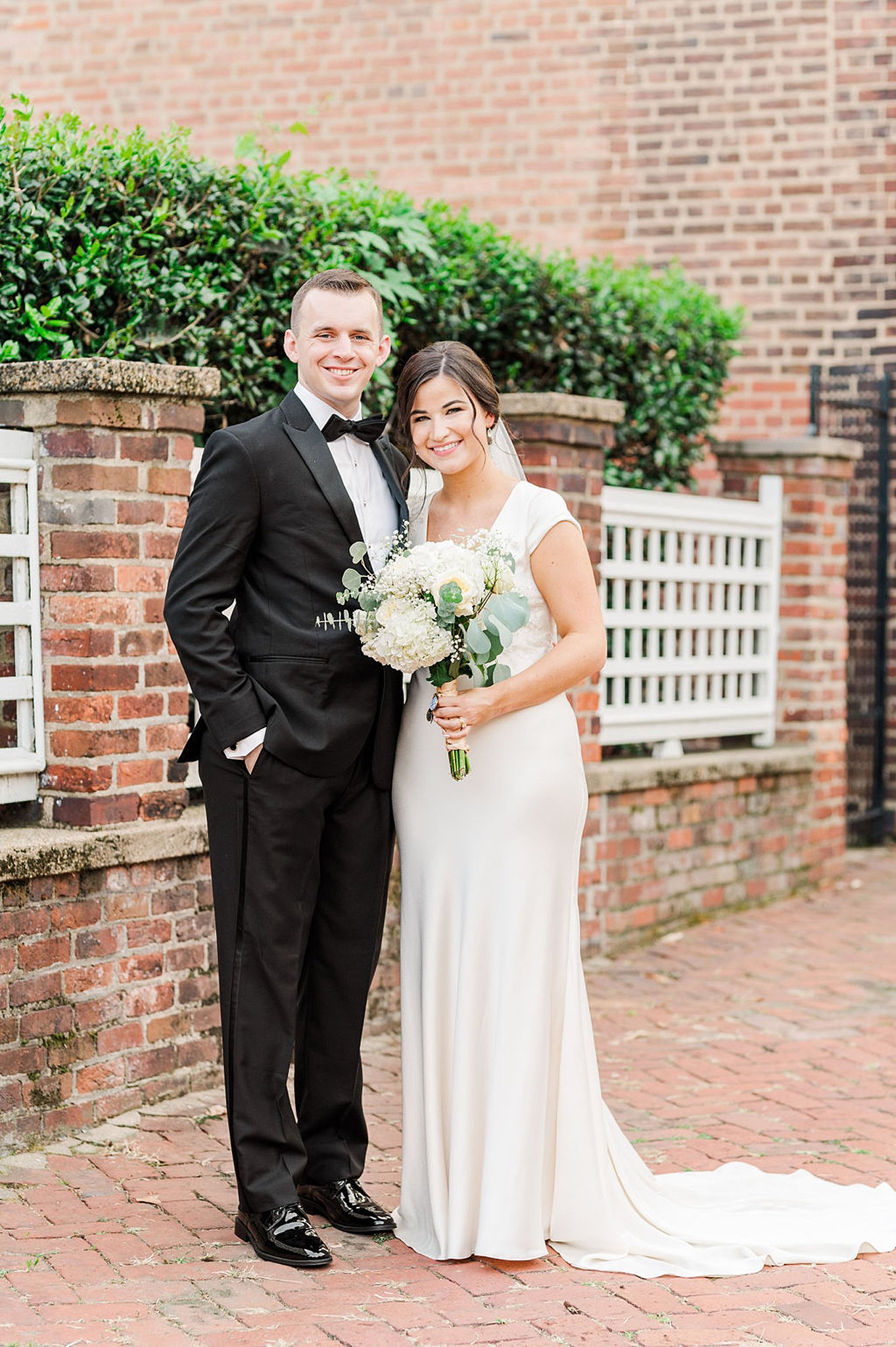 bride and groom smiling and hugging at their old town alexandria wedding