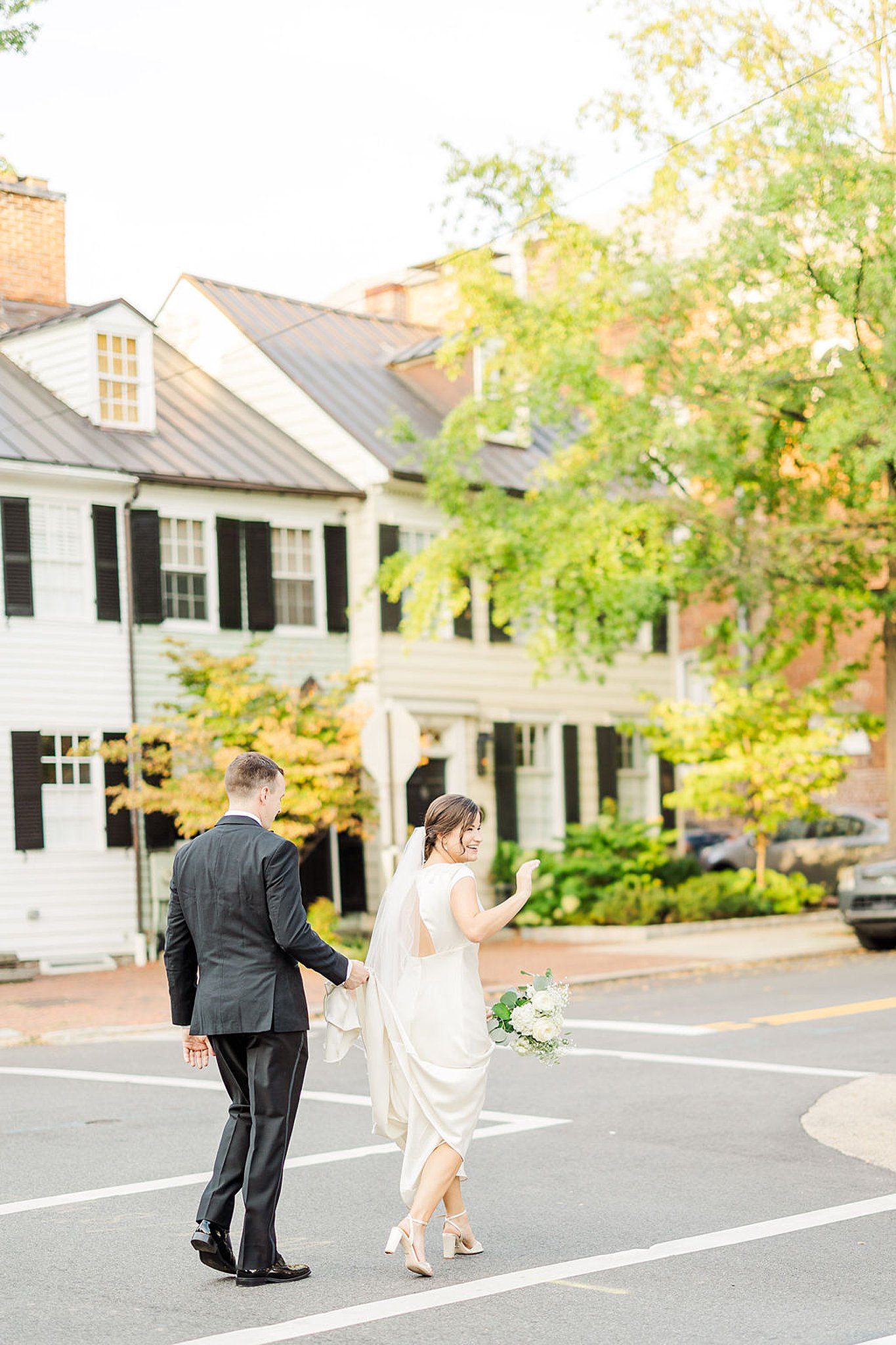 bride and groom walking through a parking lot at their old town alexandria wedding