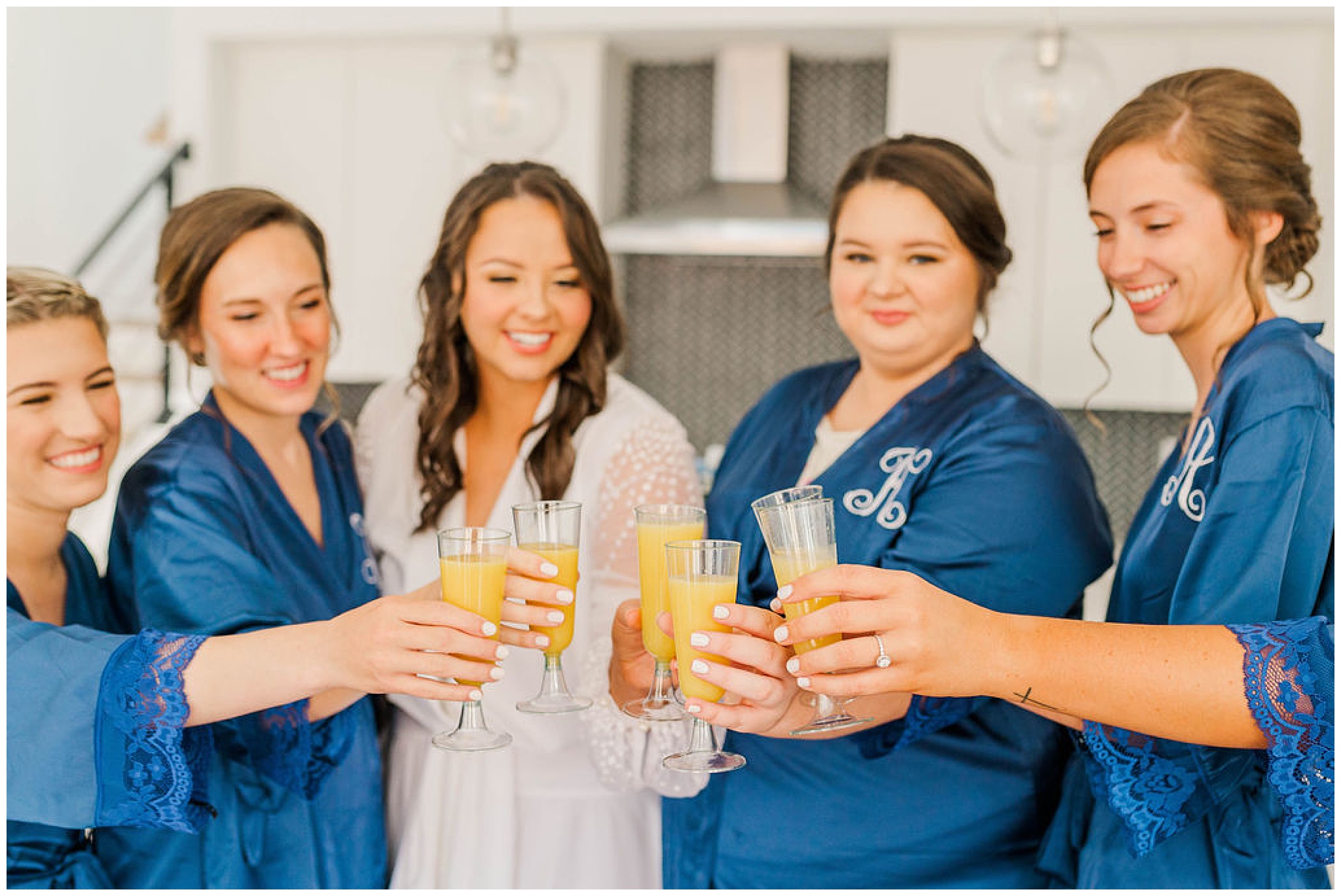 bride toasting mimosas with her bridesmaids before her wakefield plantation wedding
