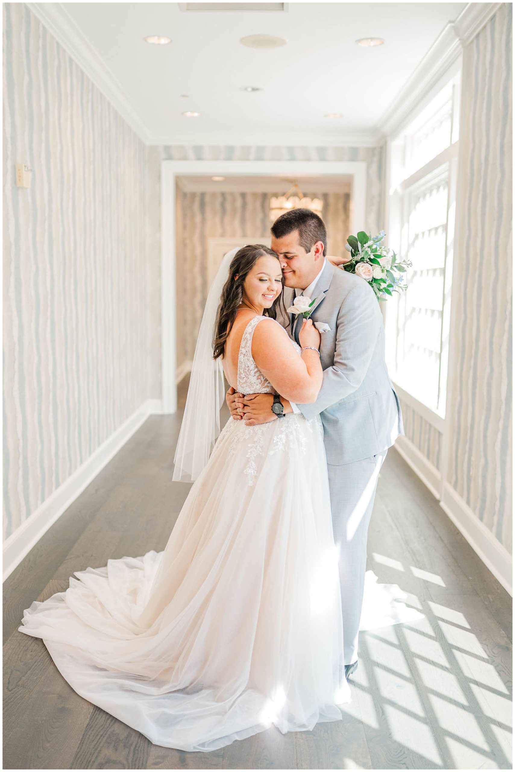 groom nuzzling his bride in a hallway at their wakefield plantation wedding