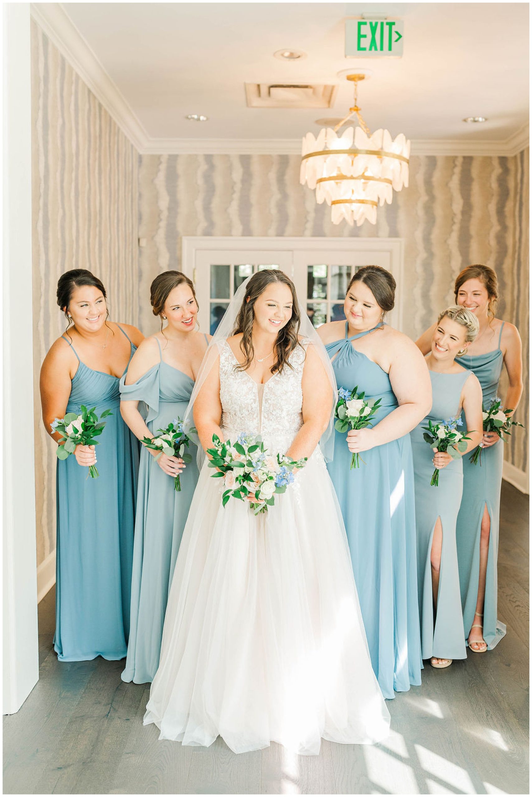 bride with her bridesmaids dressed in blue at her wakefield plantation wedding