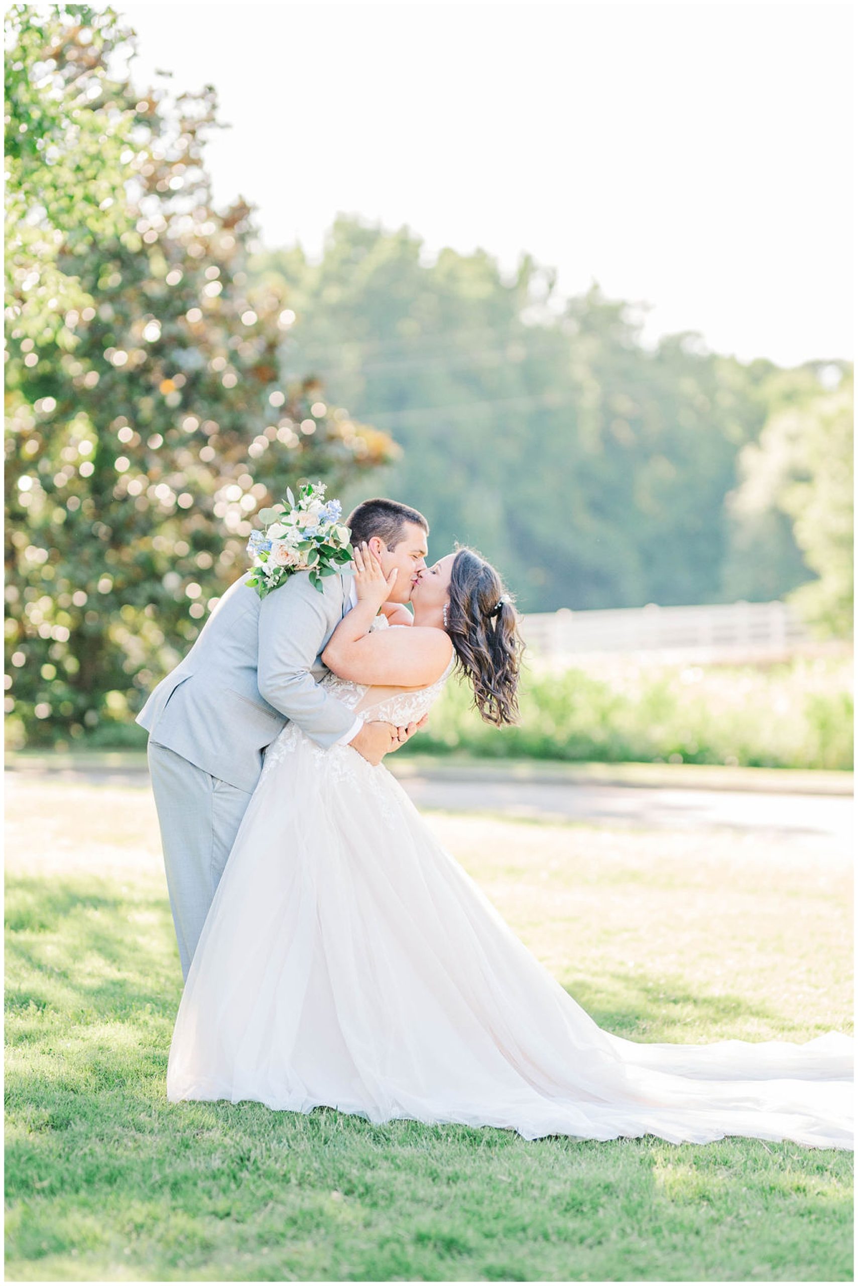 groom dipping his bride back while sharing a kiss at wakefield plantation wedding