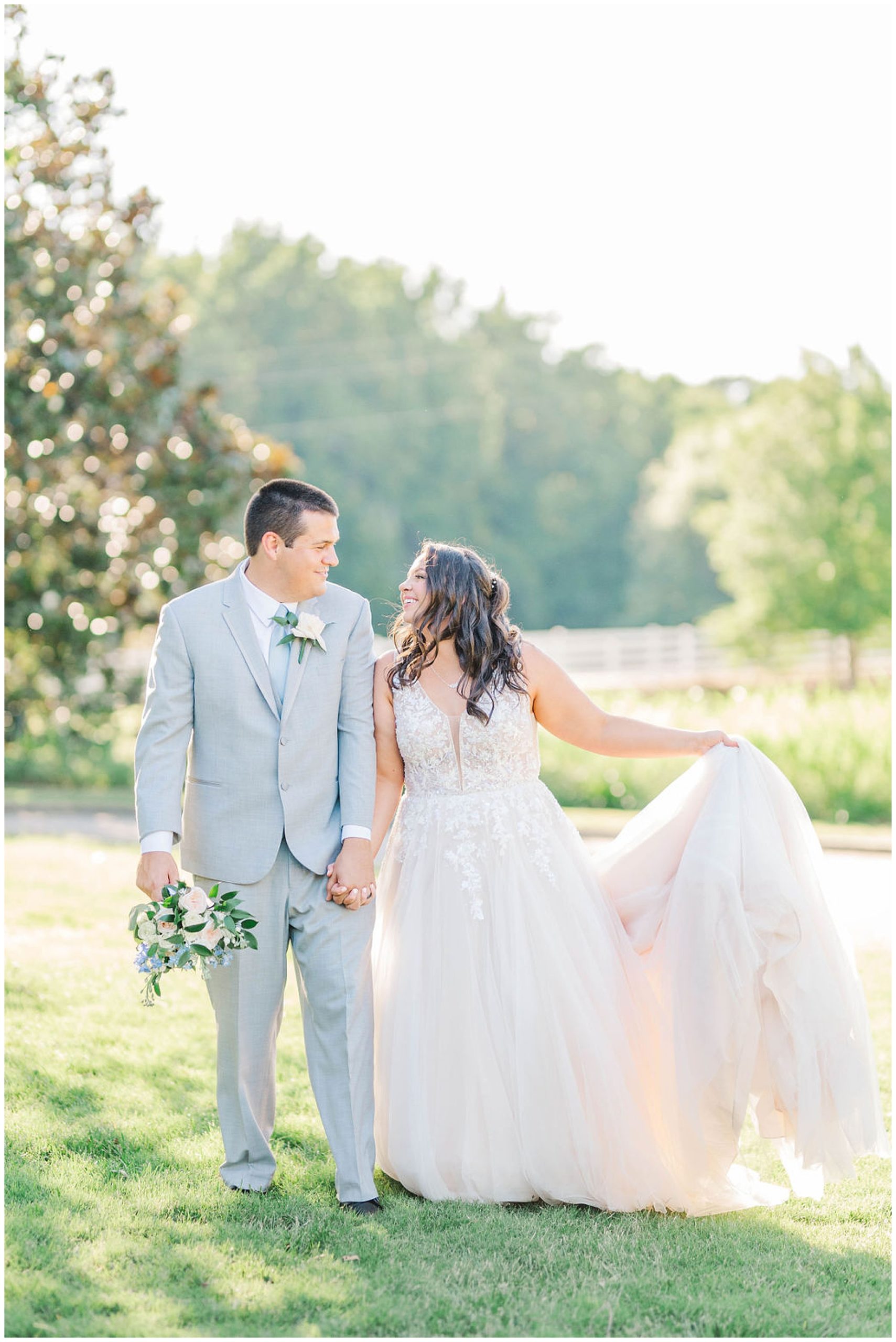 bride holding her dress and holding hands with her groom at wakefield plantation wedding