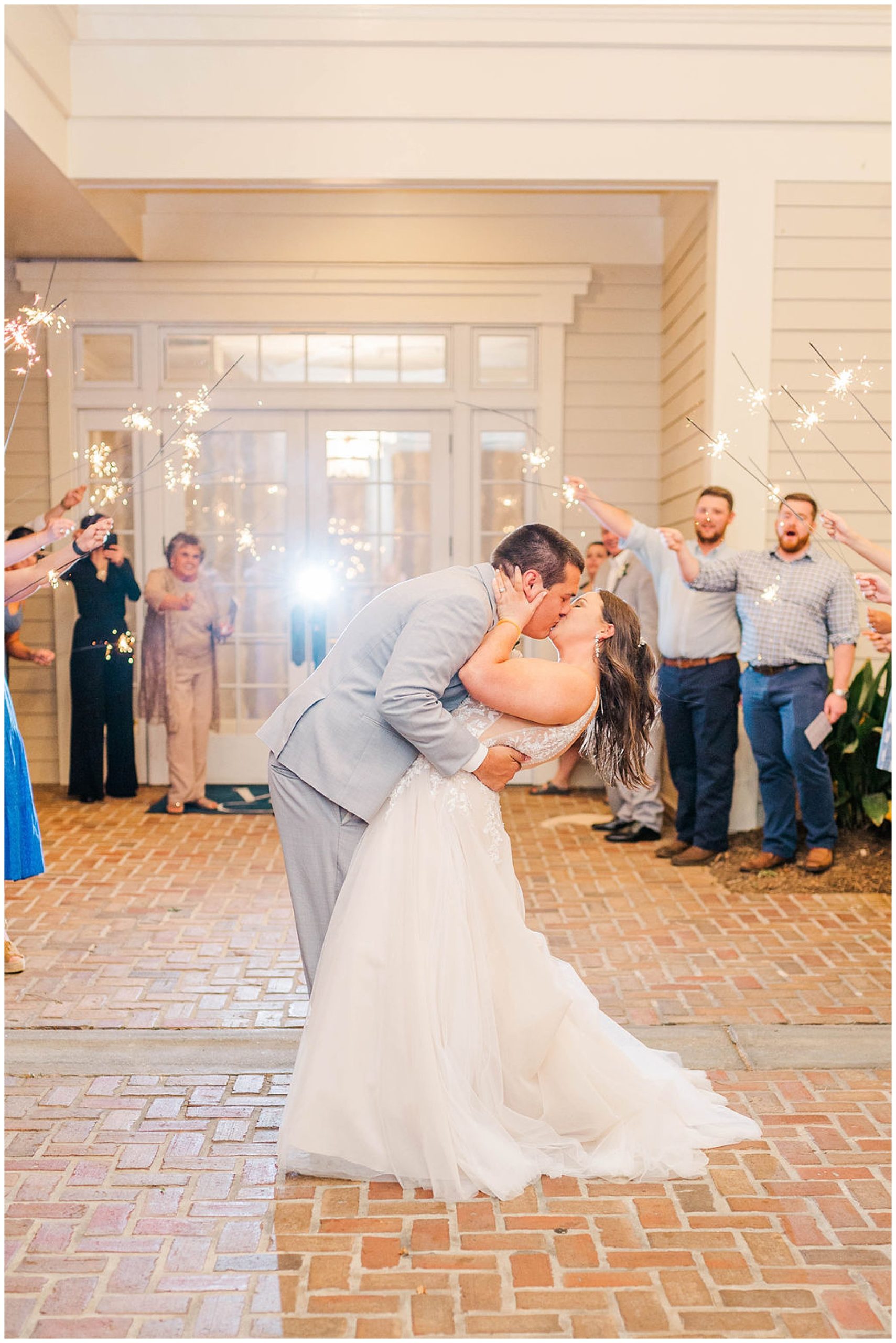 groom kissing his bride during the exit of their wakefield plantation wedding
