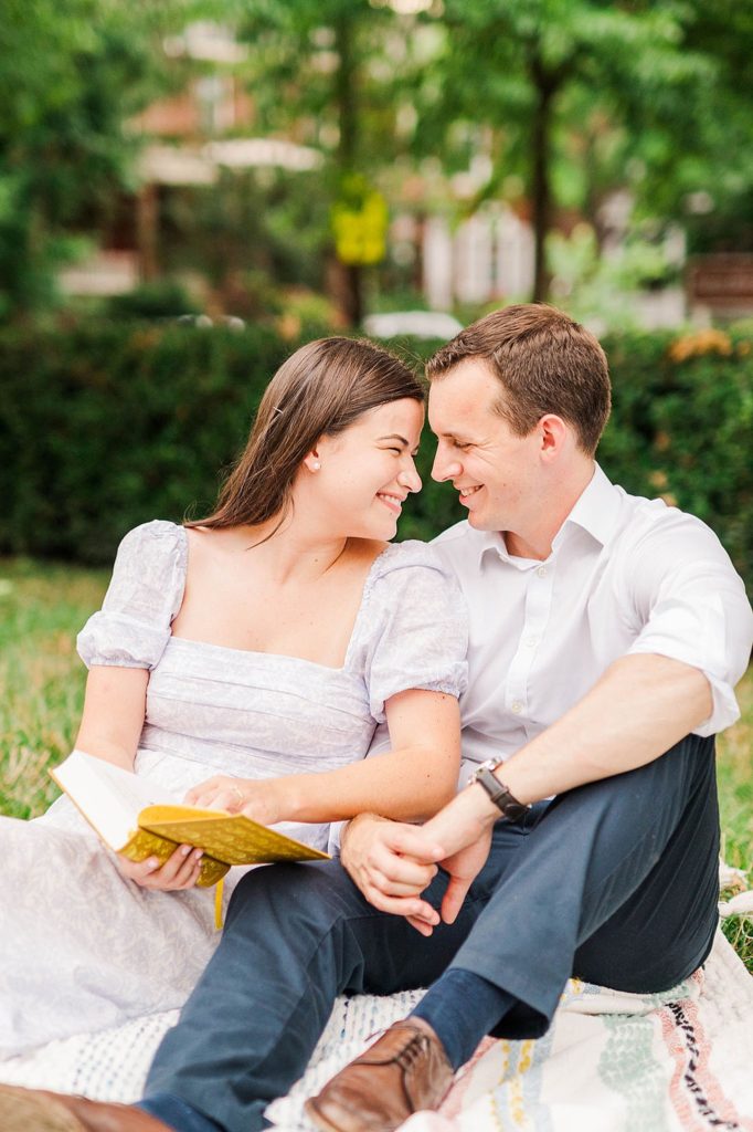 bride and groom to be sitting on a picnic blanket with a book Engagement Photos Richmond VA
