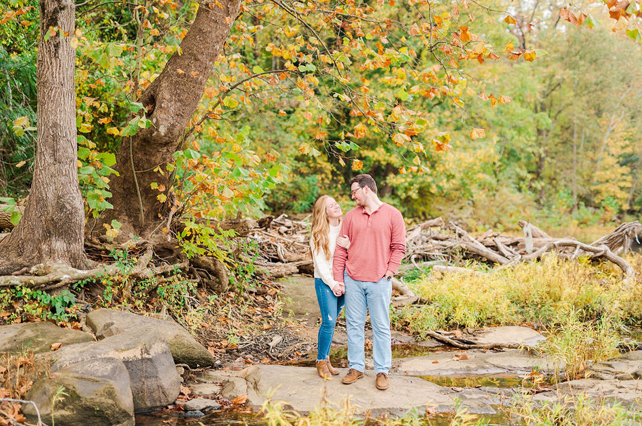 bride and groom to be standing on a rock in brown's island Engagement Photos Richmond VA