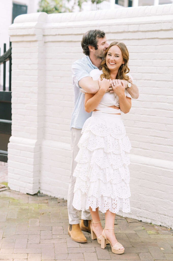 Bride in white scalloped dress during engagement photos