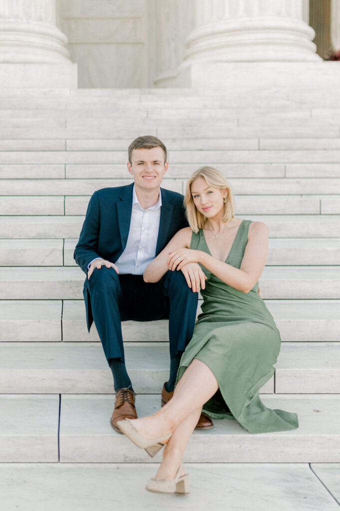 Couple sitting on the steps at the Supreme Court during engagement photos
