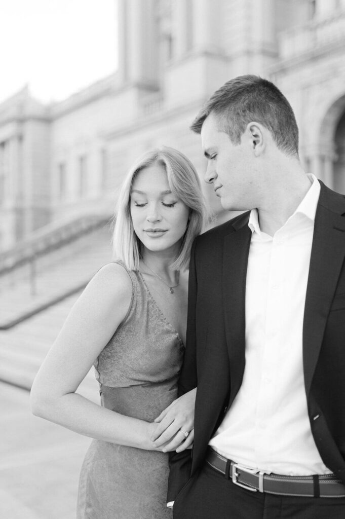 Black and white image of a man looking down towards his fiance during their engagement photos. 
