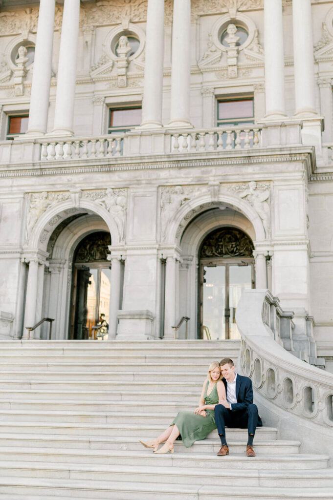Couple sitting with each other on the grand staircase outside of the Library of Congress.