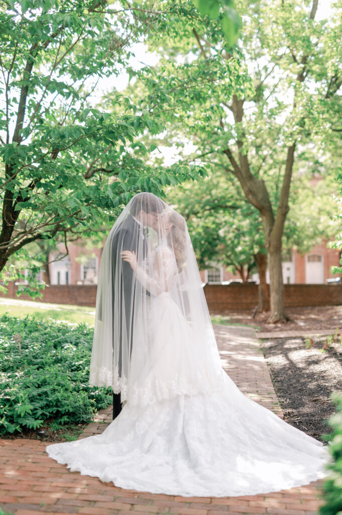 Bride and groom kissing under veil at the Carlyle House