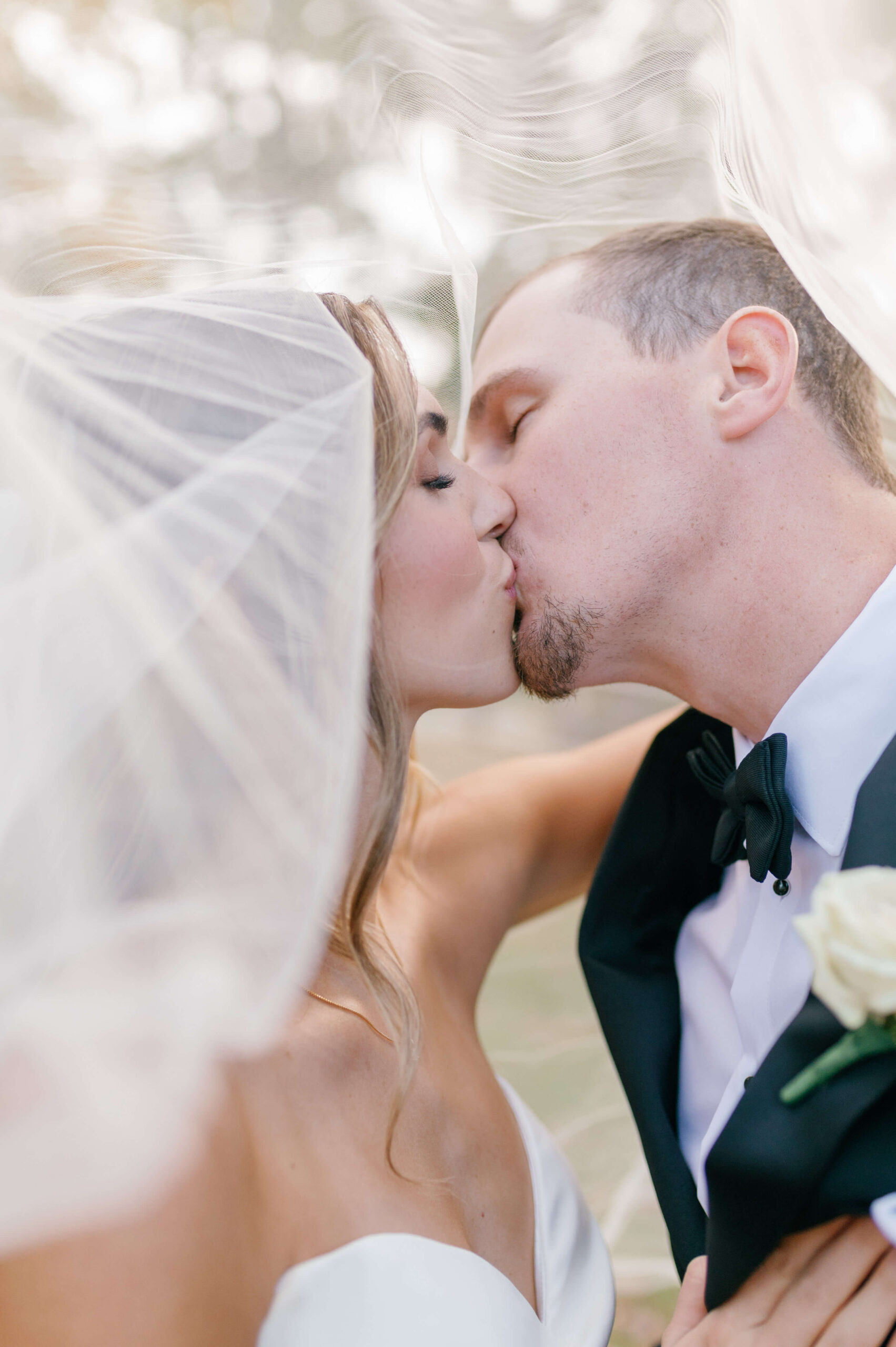Newlyweds kiss under the veil